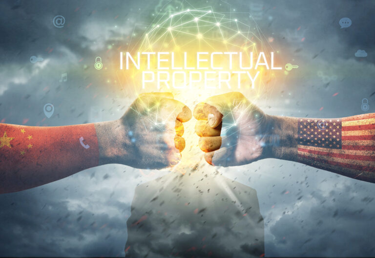Two fists, one with the Chinese flag and the other with the US flag, bump together under the words "Intellectual Property" on a cloudy background, symbolizing ongoing China-US IP disputes.