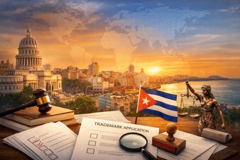 A desk with trademark application forms, a gavel, a Cuban flag, and a Lady Justice statue, with Havana’s skyline and a world map in the background at sunset.