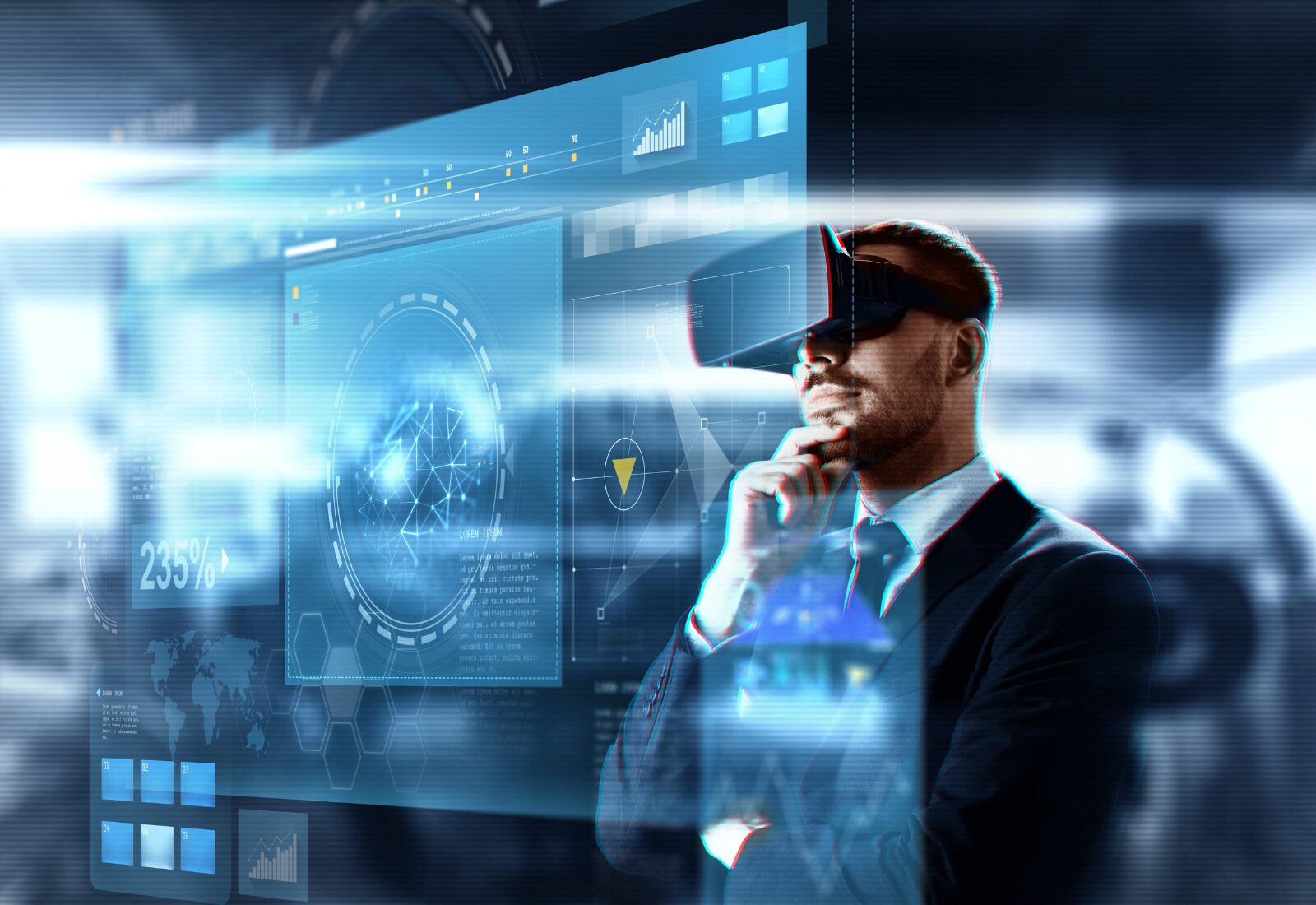 A man in a suit wearing virtual reality goggles interacts with a digital interface displaying various data and graphs.