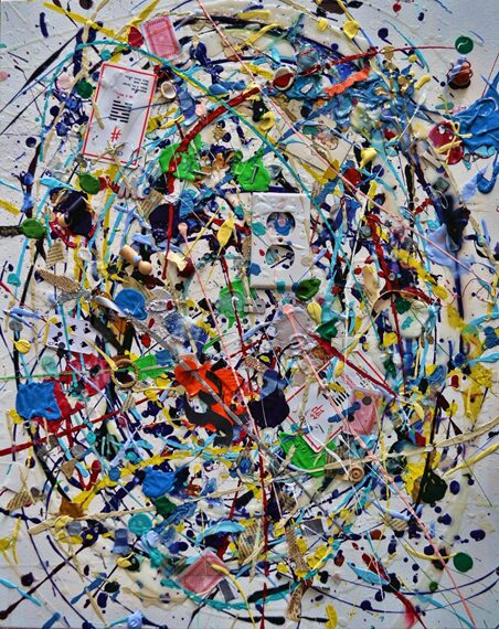 Abstract artwork featuring a chaotic mix of paint splatters, colorful swirls, and embedded objects like playing cards and puzzle pieces on a canvas.