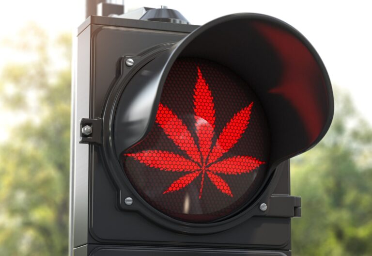 A traffic light displays a red cannabis leaf symbol instead of the usual red light, subtly hinting at the presence of intoxicating hemp products.