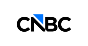 The image shows the CNBC logo with bold black letters and a blue triangle above the letter N on a white background.